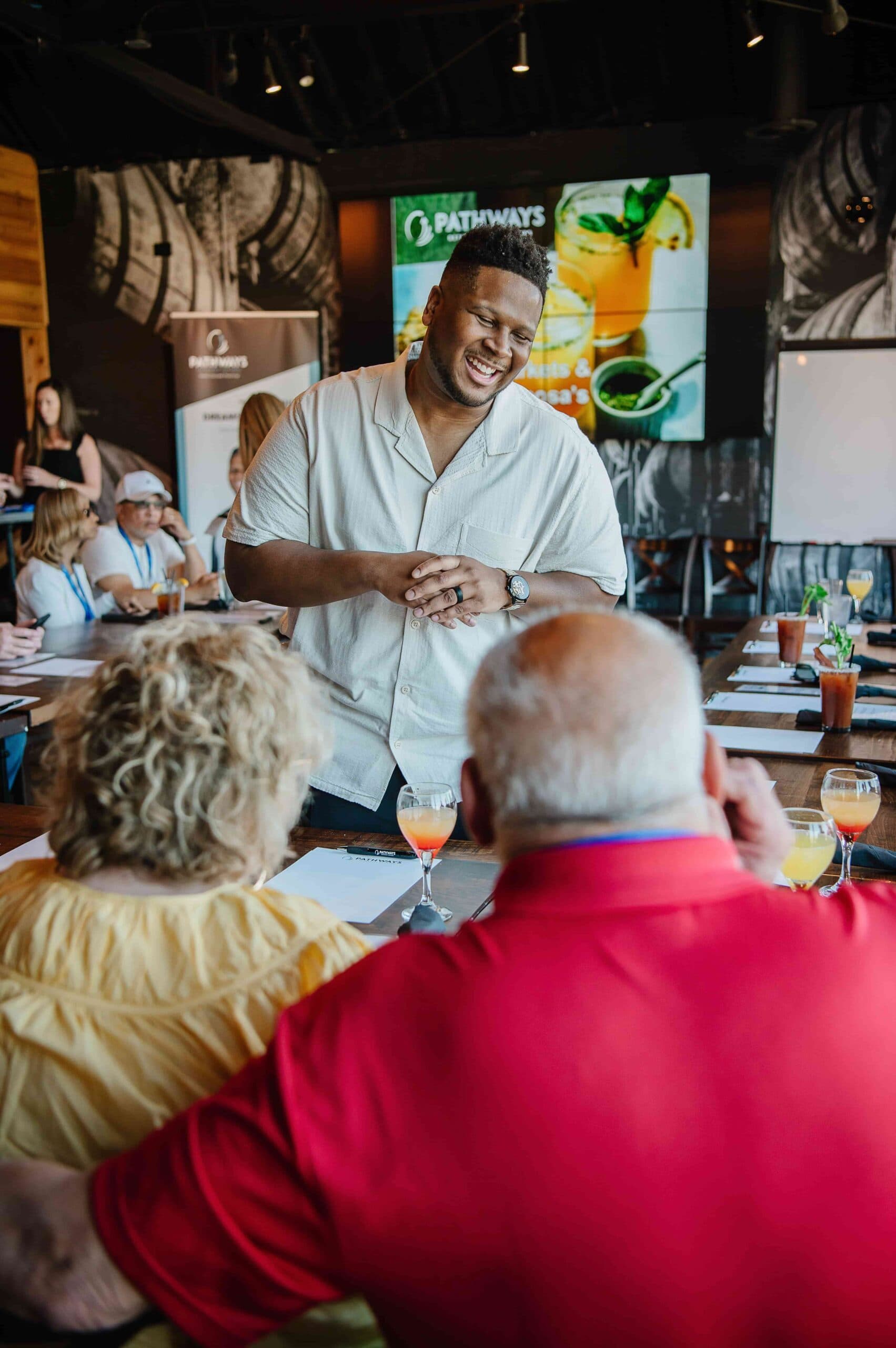 Marques Miles greeting guests at a dinner seminar